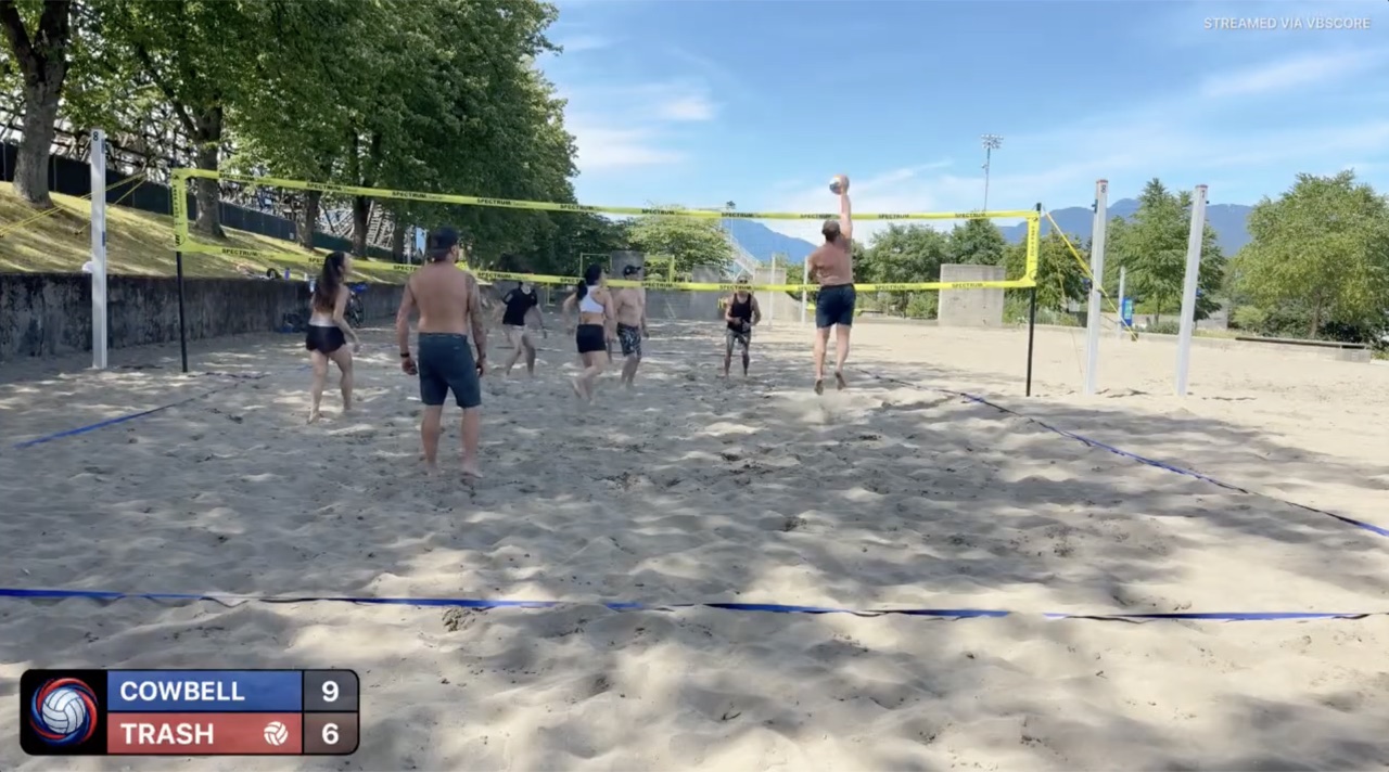Beach volleyball video with the VBScore scoreboard overlaid in the corner showing Cowbell 9, Trash 6, and a Streamed via VBScore watermark